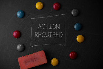 Text sign showing Action Required. Business photo text Regard an action from someone by virtue of their position Round Flat shape stones with one eraser stick to old chalk black board
