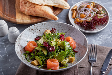 Salmon Salad with spinach, corn salad, baby spinach, fresh mint and basil. Home made food. Concept for a tasty and healthy meal. Dark stone background. Top view. Close up.