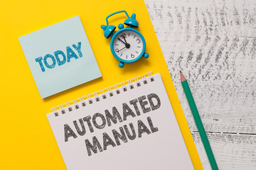 Text sign showing Automated Manual. Business photo showcasing as trigger shift and it can switch between moods easily Spiral notepad paper sheet marker alarm clock retro wooden background