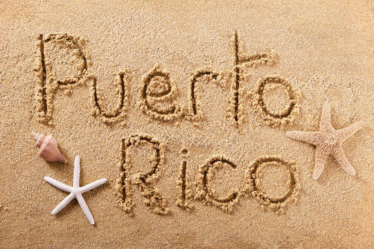 Puerto Rico word written in sand sign writing drawing drawn on a sunny summer beach with starfish holiday vacation travel destination message photo