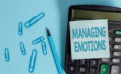 Writing note showing Managing Emotions. Business concept for Controlling feelings in oneself Maintain composure Electronic calculator blank sticky note clips marker colored background