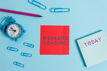 Writing note showing Weekend Loading. Business concept for Starting Friday party relax happy time resting Vacations Alarm clock wakeup clips notepad sticky note pencil colored background