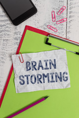 Handwriting text Brain Storming. Conceptual photo Stimulating creative thinking Developing new ideas Discussion Clipboard paper sheet pencil smartphone note clips wooden retro background