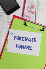 Writing note showing Purchase Funnel. Business concept for consumer model which illustrates customer journey Clipboard sheet pencil smartphone squared note clips wooden background