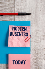 Word writing text Modern Business. Business photo showcasing Introduction to the philosophy of large corporate enterprise Wrinkle paper and cardboard plus stationary placed above wooden background