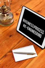 Handwriting text writing Business Process Re Engineering. Conceptual photo the analysis and design of workflows Writing equipments placed next to gadget plus a classic vintage lantern