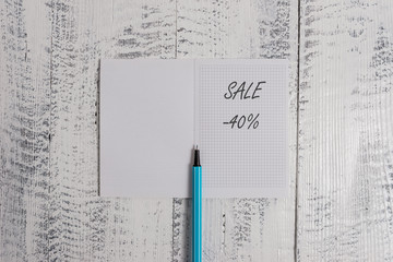 Conceptual hand writing showing Sale 40 Percent. Concept meaning A promo price of an item at 40 percent markdown Square notebook fine highlighter lying on wooden background