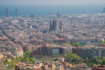 Fototapeta premium Barcelona, Spain - April, 2019: View of Barcelona city and costline in spring from the Bunkers in Carmel neighborhood. Few building stand out like sagrada familia and Agbar tower