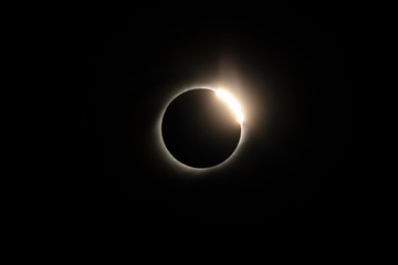 The Baily's beads effect and Diamond Ring effect during Total Solar Eclipse Chile 2019, amazing view of the Sun covered by the Moon during totality phase while the last sunbeams pass the Moon craters