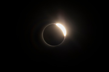 The Baily's beads effect and Diamond Ring effect during Total Solar Eclipse Chile 2019, amazing view of the Sun covered by the Moon during totality phase while the last sunbeams pass the Moon craters