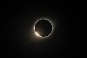 The Baily's beads effect and Diamond Ring effect during Total Solar Eclipse Chile 2019, amazing view of the Sun covered by the Moon during totality phase while the last sunbeams pass the Moon craters