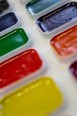 Multicolored watercolor paint in white box