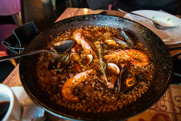 Traditional Spanish paella with seafood and chicken. Prepared in wook.