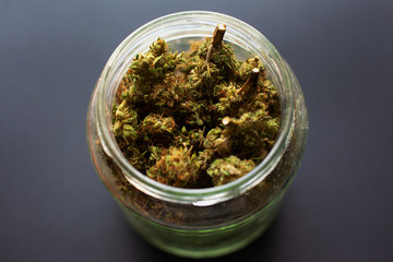 jar of dried and treated marijuana buds ,medical odorous cannabis from the fridge 