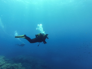 Naklejka na ściany i meble Young female scuba diver in Atlantic ocean