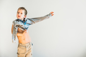 Child undressing before going to sleep, alone, learning to be independent.