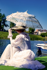 Lady sitting by the water on a sunny day