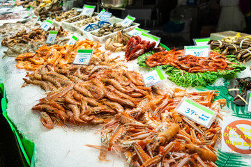 BARCELONA, Spain - April, 2019: Tourists in famous La Boqueria market in Barcelona one of the oldest markets in Europe that still exist. Established 1217.