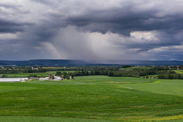 Fototapeta na wymiar Rain Over Pennsylvania Farmland in Front of the Blue Mountain