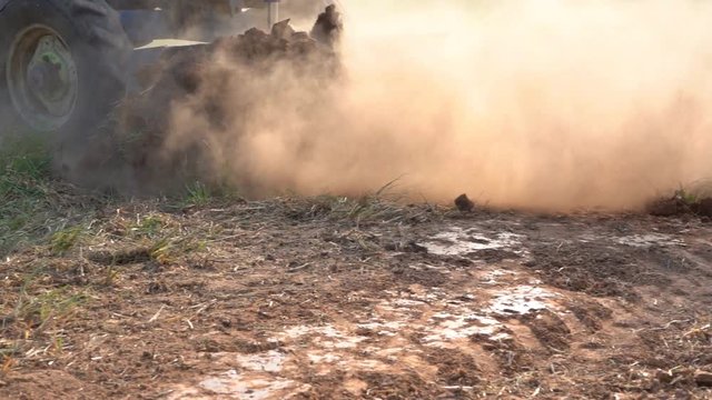 Slow motion tractor working in farmland agriculture for plant seeding  