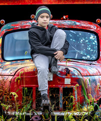 young man sitting on vintage truck