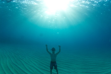 silhouette of man underwater