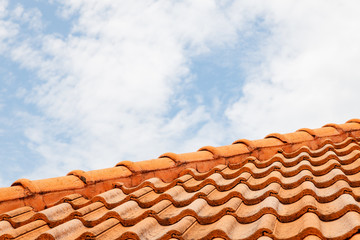 Close up of brown clay roof tiles. Red old dirty roof. Old roof tiles. Construction equipment build a house.
