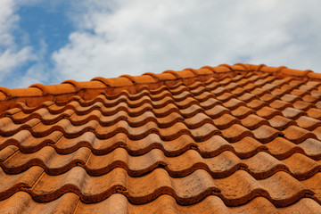 Close up of brown clay roof tiles. Red old dirty roof. Old roof tiles. Construction equipment build a house.