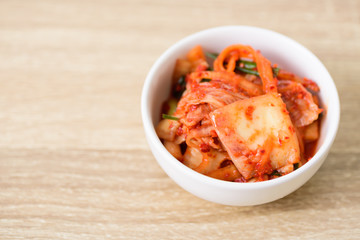 Kimchi cabbage in a bowl on wooden background, Korean food