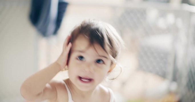 Incredible cute baby girl playing indoors. Shot on a cinema camera in 4K RAW.