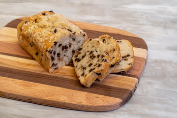 Loaf of sliced chelate chip bread on wooden cutting board