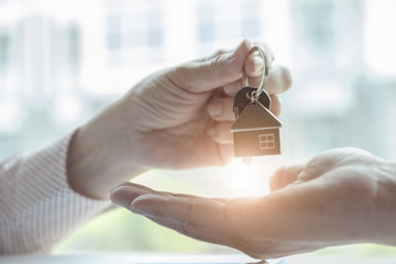 Real estate agents agree to buy a home and give keys to clients at their agency's offices....