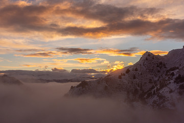 Winter sunset in the Andes mountains with fog in the valley