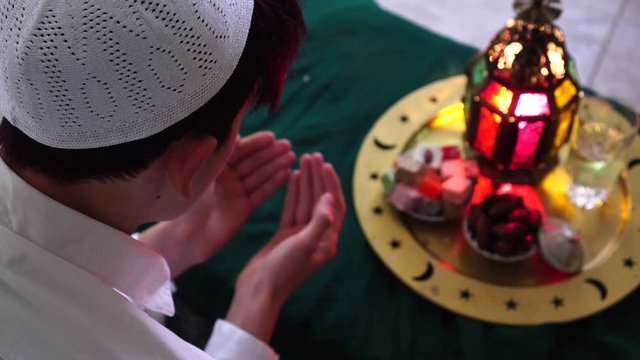 Eid al-Adha Islamic holiday. Eid prayers. Feast of the Sacrifice. Kurban Bayram. Religious muslim man praying