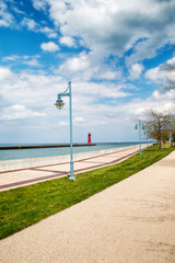 Obraz premium red lighthouse by the edge of the sea