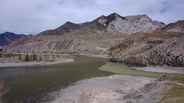 Video from a drone taking off overlooking the confluence of the rivers Chuya and Katun in Spring season. Altai, Siberia, Russia