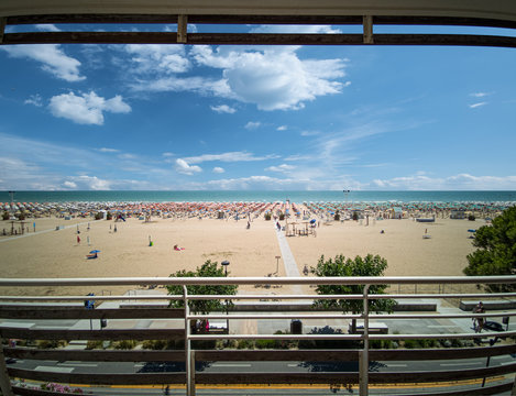 Bibione spiaggia, tra ombrelloni e bagnanti che prendono il sole per la abbronzatura estiva in una bella giornata