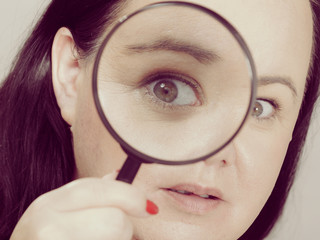 Adult woman with magnifying glass