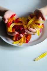 photo man holding jelly worms in his hands in a plate