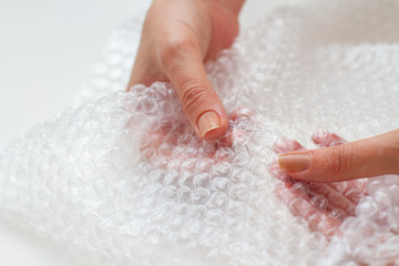 Using Pop It. Woman's fists squeezing the bubble Wrap. Double dimple.
