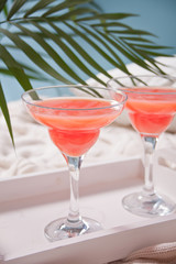 Pink exotic alcoholic cocktail in clear glass