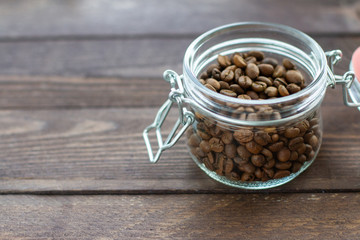 coffee beans in a glass on wooden table