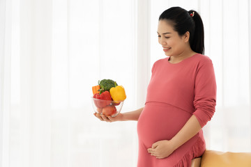 Pregnant women hold fruits and vegetables. Healthy food of pregnant women