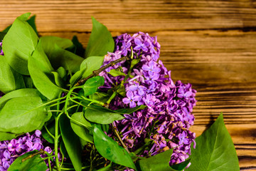 Flowers of lilac plant on wooden background