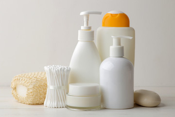 Personal hygiene products. Body care cosmetics. White bottles and vials on a light background. SPA. Relax.