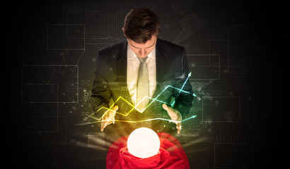 Young businessman making predictions of the future of the stock market with a magic ball