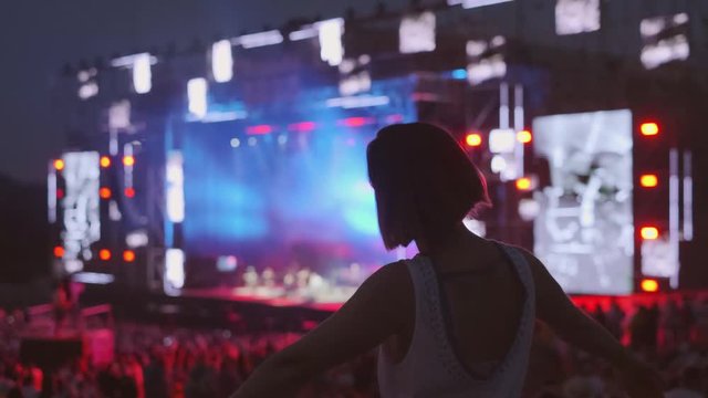 Woman is dancing at open air music festival