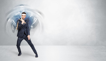Obraz premium Young businessman in suit fighting with empty wall background