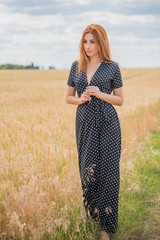 Elegant woman in long black polka dot dress at the field  © T.Den_Team