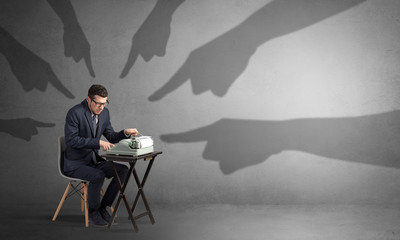 Shadow hand pointing at a small afraid worker